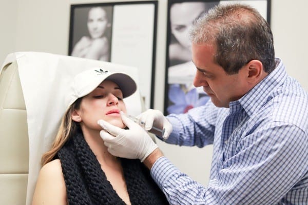 Dr. Miller performing non-surgical filler treatment for young woman